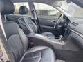 Interior view of a 2007 Mercedes-Benz E-Class featuring black leather seats and a console with a gear shift and control panel