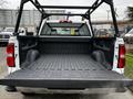 A 2018 GMC Sierra 1500 with an open bed showing a rugged, lined interior featuring side contours and mounting points for cargo management