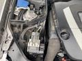 2007 Mercedes-Benz E-Class engine compartment featuring various engine components including hoses and an electronic control unit