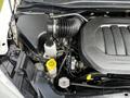 Engine compartment of a 2011 Dodge Grand Caravan showing the air intake and various engine components including a reservoir and hoses