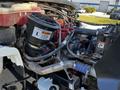Close-up view of the engine compartment of a 2016 Freightliner M2 106 showing various engine components and hoses