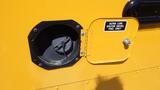 Close-up of a fuel door on a yellow 2014 Freightliner Thomas Bus Diesel with a cap labeled for ultra low sulfur diesel fuel only