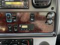 Control panel of a 2016 Freightliner M2 106 featuring various switches buttons and dials for vehicle operations and power outlets