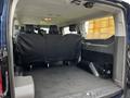 Interior view of a 2020 Ford Transit showing two black leather seats folded down in the rear cargo area