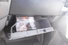 A 2012 Mercedes-Benz Sprinter's glove compartment is open revealing papers and an instruction manual inside