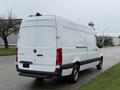 A 2019 Mercedes-Benz Sprinter van with a white exterior and rear doors visible, showcasing its spacious design and cargo capacity