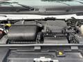 Close-up of the engine compartment of a 2022 Ford E-450 showing the engine components including air filter housing and various hoses and wires