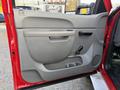 Interior door panel of a 2013 Chevrolet Silverado 3500HD featuring a handle cup holder and manual window control