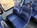 Two blue, upholstered passenger seats in the interior of a vehicle