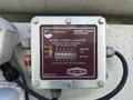 A FloTech model FT204 retain and overfill monitor with a serial number and indicator lights for power and sensor statuses at the top and bottom