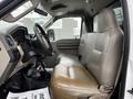 Interior view of a 2008 Ford F-450 SD featuring a spacious beige leather bench seat and a simple dashboard design