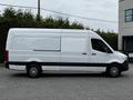 A white 2019 Mercedes-Benz Sprinter van with a high roof and sliding side door shown from the side