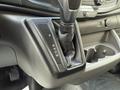 The gear shift of a 2021 Ford Transit featuring options for park reverse neutral drive and low gear with a leather boot