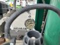 A pressure gauge measuring up to 5000 psi with markings for 1000 2000 and 3000 psi connected to equipment on a trailer