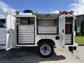 A 2024 Ford F-550 service truck with an open side door displaying organized tool drawers and equipment compartments