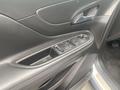 Interior door panel of a 2018 Buick Encore featuring window controls and a sleek design with black upholstery and chrome accents