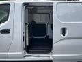 A 2020 Nissan NV200 van with an open side door revealing the cargo area inside
