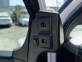Close-up of the control panel on the driver's side of a 2017 Chevrolet Express featuring two buttons and a switch