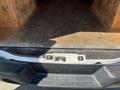 The rear doors of a 2012 Chevrolet Express van with wooden paneling visible inside the cargo area