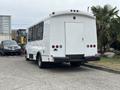A white 2020 Chevrolet Express van with a rear door and multiple tail lights parked in a lot