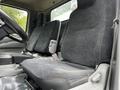 Interior of a 2014 Hino 195 showing two fabric seats designed for driver and passenger with a simple dashboard visible in the foreground