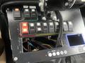 Dashboard of a 2016 Chevrolet Express showing various switches buttons and wiring in the foreground