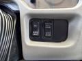 The interior control panel of a 2018 International DuraStar featuring two buttons labeled WORK LIGHT and 6TH GEAR