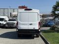 A white 2022 Ford Transit van viewed from the rear with no visible markings on the back door