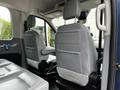 Interior view of a 2017 Ford Transit 350 showing two gray leather seats with headrests and a spacious arrangement for passengers or cargo