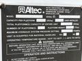 A metal identification plate with the Altec Industries logo displaying model information and specifications for a 2006 GMC C7C00 vehicle