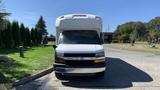 Front view of a white 2011 Chevrolet Express with a large cargo area and a Chevrolet emblem on the grille