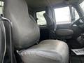 Interior view of a 2008 International 7500 truck featuring two gray fabric seats with a large driver's seat and a smaller passenger seat