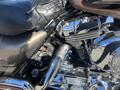 Close-up of a 2004 Harley-Davidson Flhtcui motorcycle engine with chrome detailing and black components