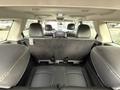Interior view of a 2013 Dodge Journey showcasing the rear seating area with black leather seats and a spacious layout