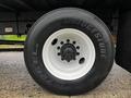 Close-up of a Bridgestone tire on a 2020 Hino 338 truck with a white rim showing lug nuts and the tire size marked on the sidewall