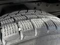 Close-up of a tire from a 2010 Ford Ranger showing detailed tread patterns and some surface dust