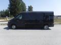 A black 2017 Ford Transit van parked on the street with a boxy design and a high roof