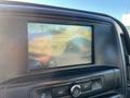 A dashboard display showing a rearview camera perspective with red guiding lines for parking in a 2018 GMC Sierra 1500