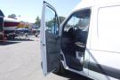 A 2012 Mercedes-Benz Sprinter van with an open driver's side door revealing the steering wheel and dashboard interior