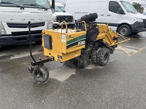2014 Vermeer Corporation Sweep Stump Cutter with large rear wheel an engine at the back and a cutting blade at the front designed for grinding tree stumps