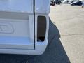 Close-up of the rear tail light area of a white 1962 Ford F-100 truck showing detailed contours and mounting location for the tail light lens