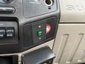 Dashboard of a 2008 Ford F-550 showing various switches and controls including a green power switch and knobs for auxiliary functions