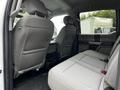 Interior view of a 2020 Ford F-350 SD showing the rear seating area with two gray upholstered seats and a spacious cabin design