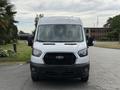Front view of a white 2022 Ford Transit with a distinctive grille and headlights visible