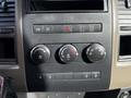 Controls and knobs for climate and vehicle settings on the dashboard of a 2012 Dodge Ram 5500