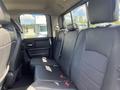 Interior view of the back seat of a 2011 RAM 1500 with black leather seating and headrests