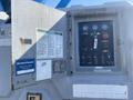 Control panel of a 1997 Genie S-65 4X4 featuring gauges buttons and switches for operation and safety notices