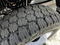 Close-up of a rugged tire tread designed for a 2024 Ford F-550 featuring deep grooves and traction patterns for off-road capability