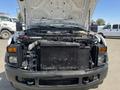 2008 Ford F-450 SD with the hood lifted displaying the engine compartment featuring various components like the radiator and air intake system