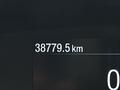 A digital display showing the mileage of a vehicle indicating 38779.5 km